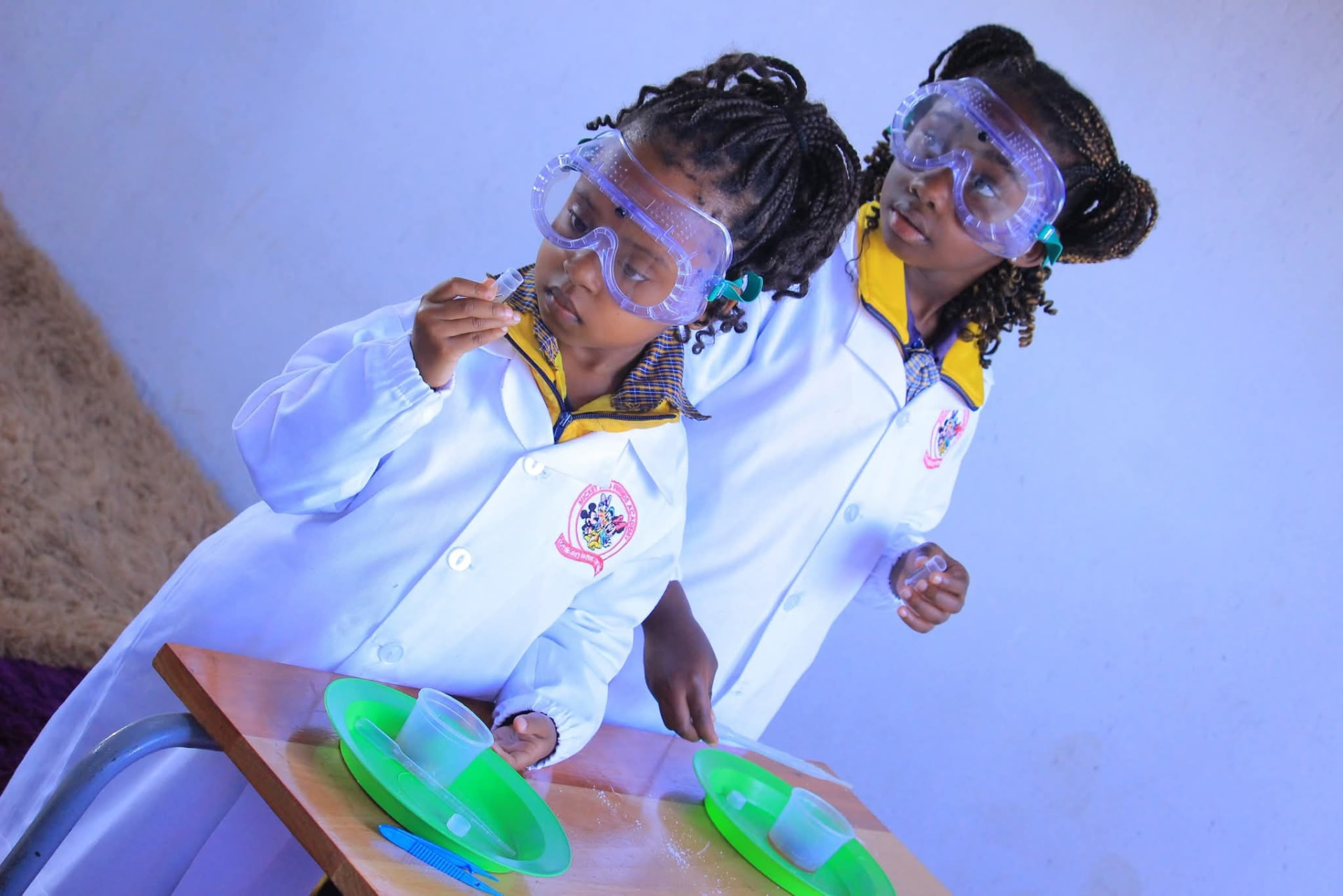 Two young scientists examining specimens with pipettes and trays