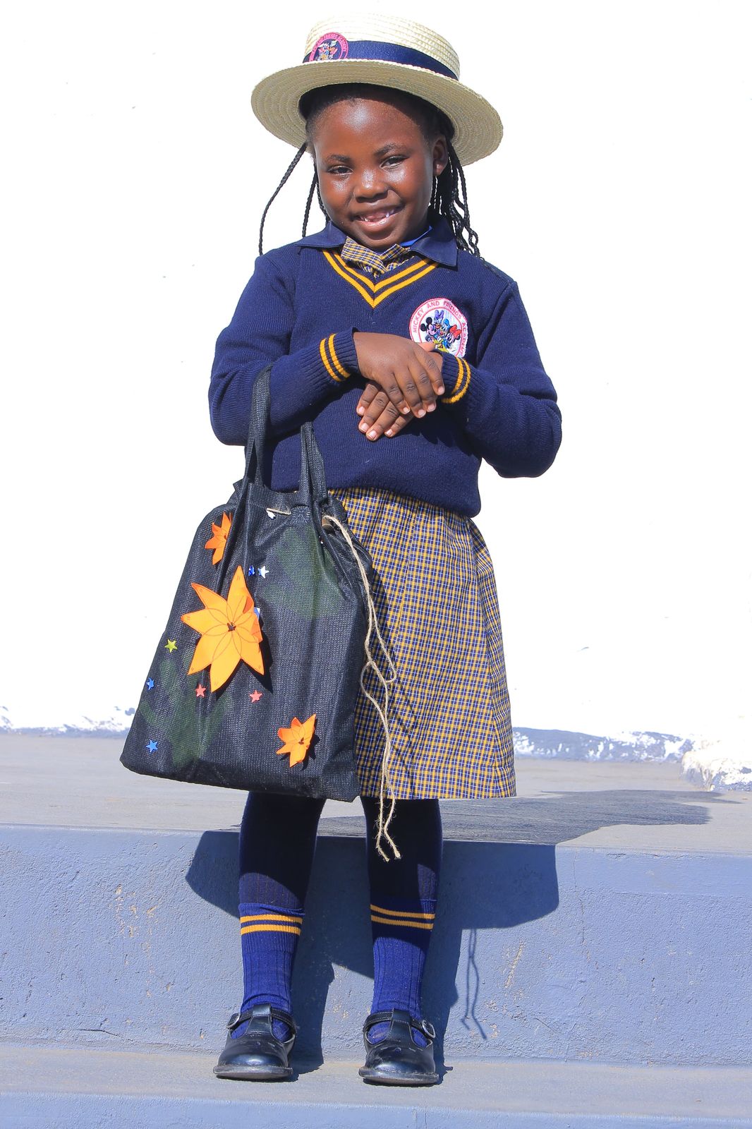 Girl holding a black tote bag decorated with paper flowers