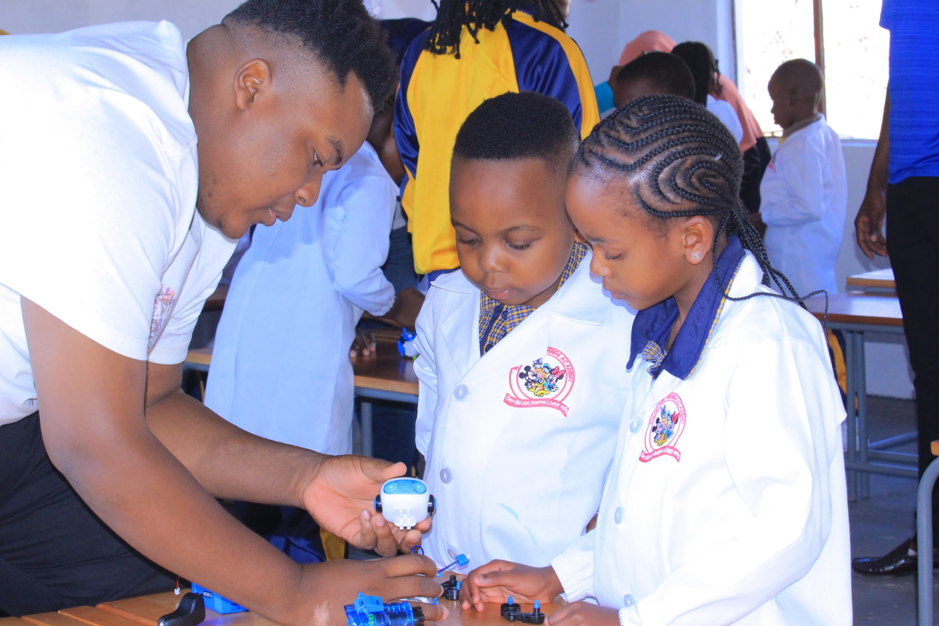 Learners assembling a robot with their teacher
